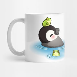 Happy emperor penguin chick with frog Mug